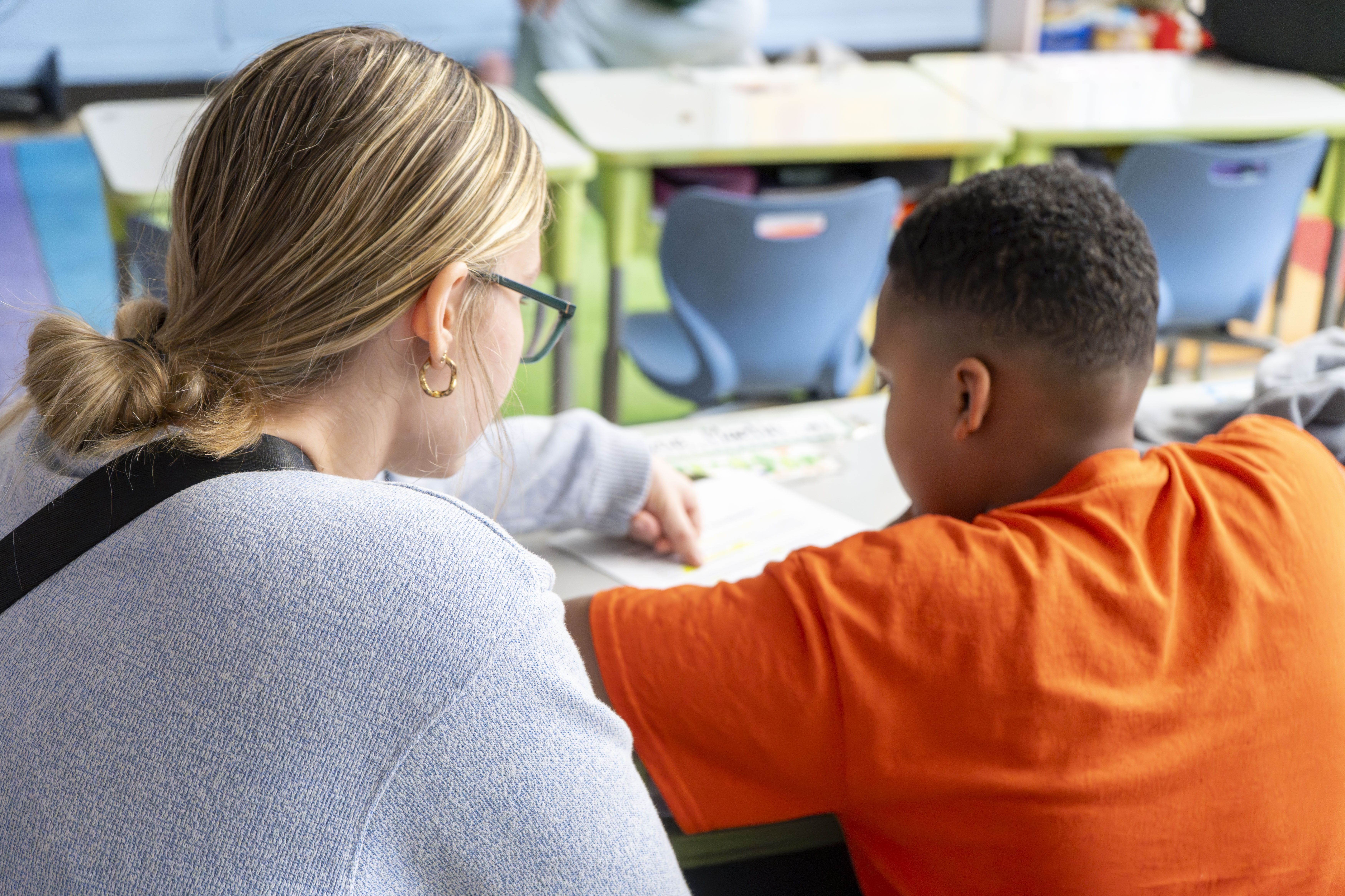 Elementary Education student tutoring a young kid in classroom