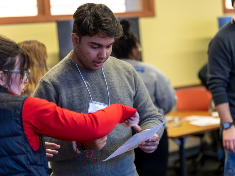 Male student seeking help with forms at Spring Orientation