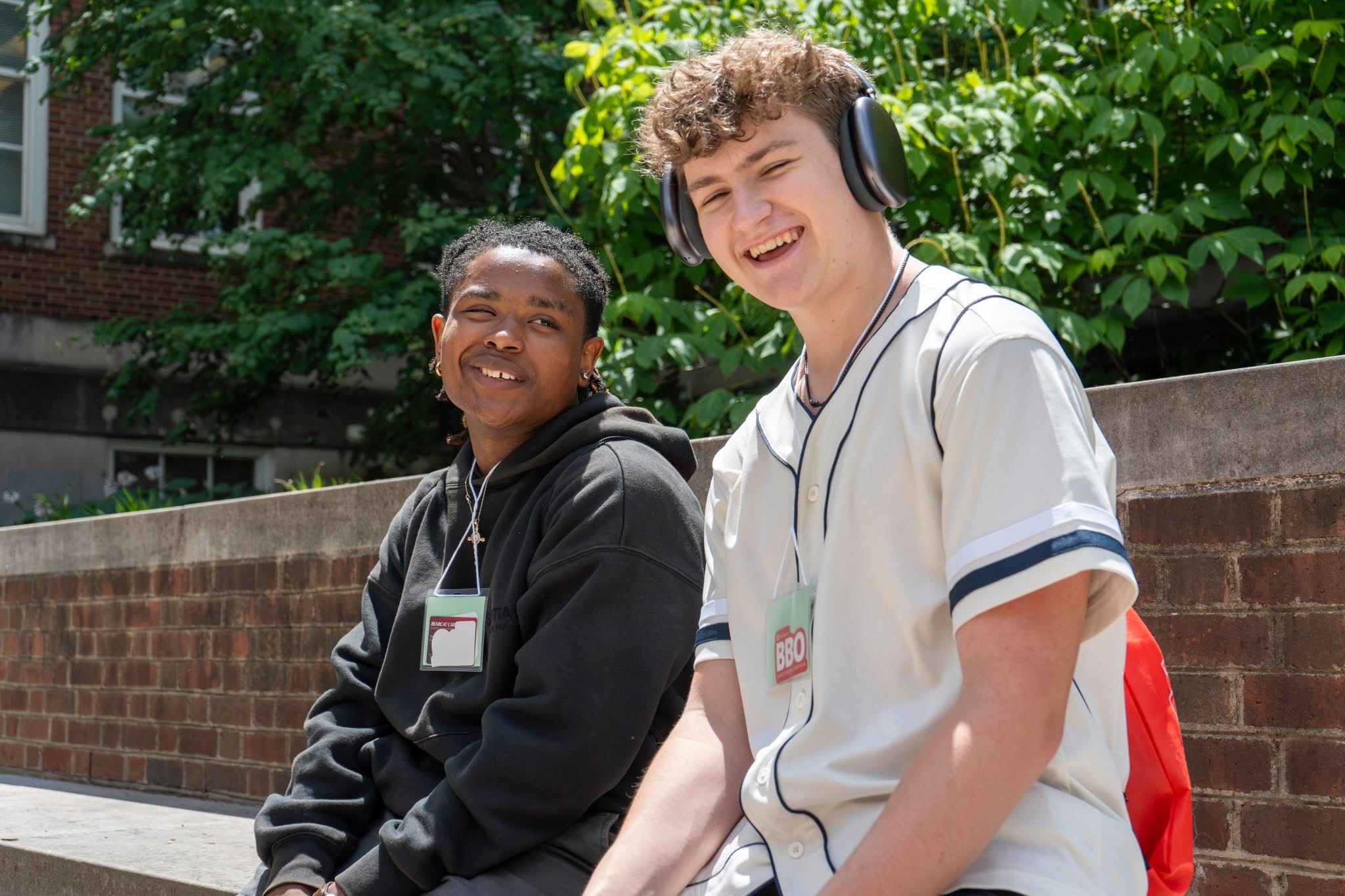Two male students sitting outside of the CECH building