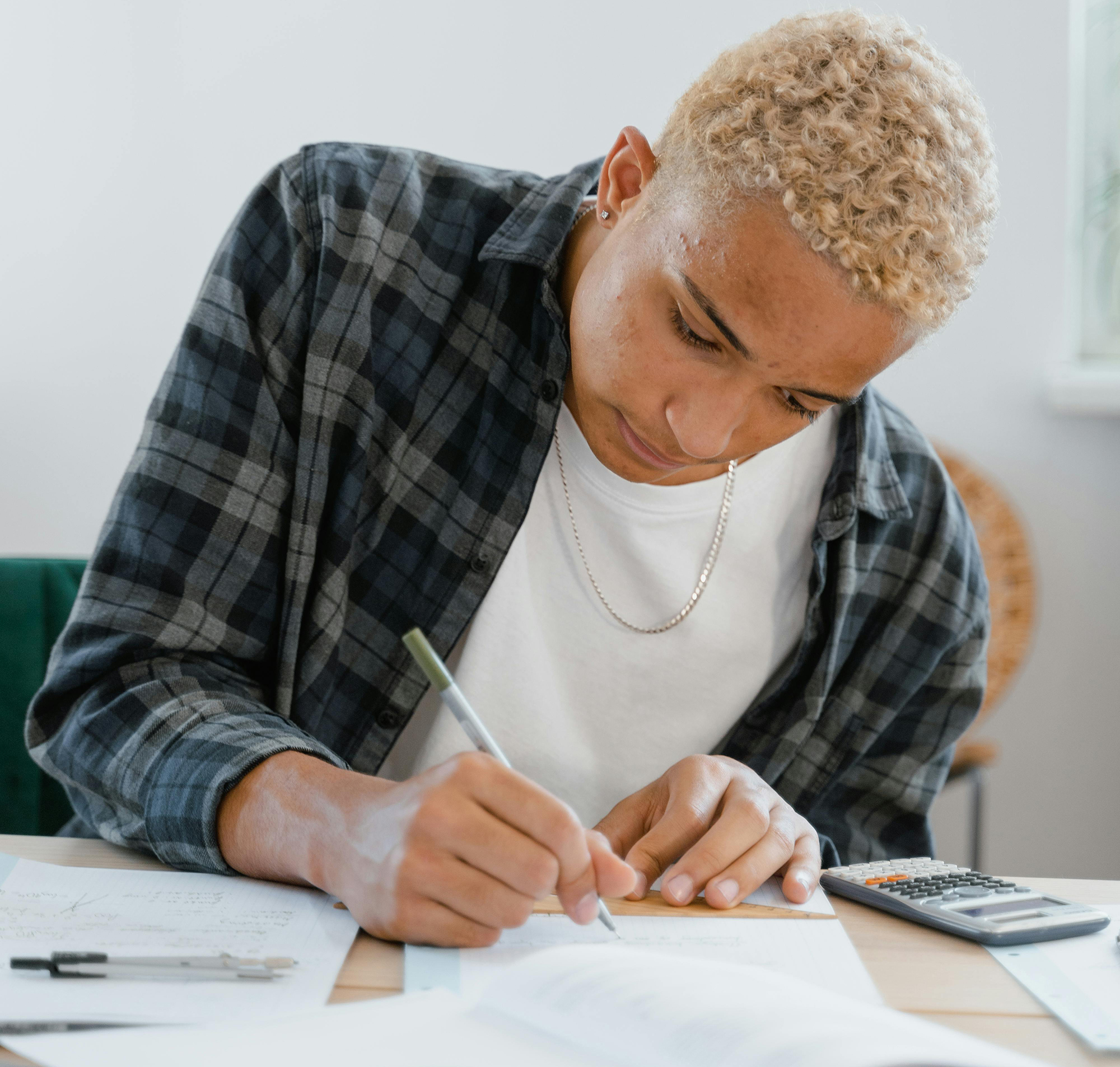 Student writing on paper