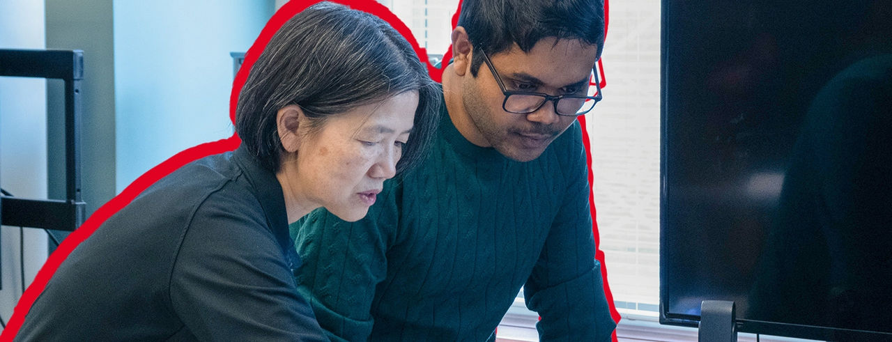 Professor and student in classroom working on project