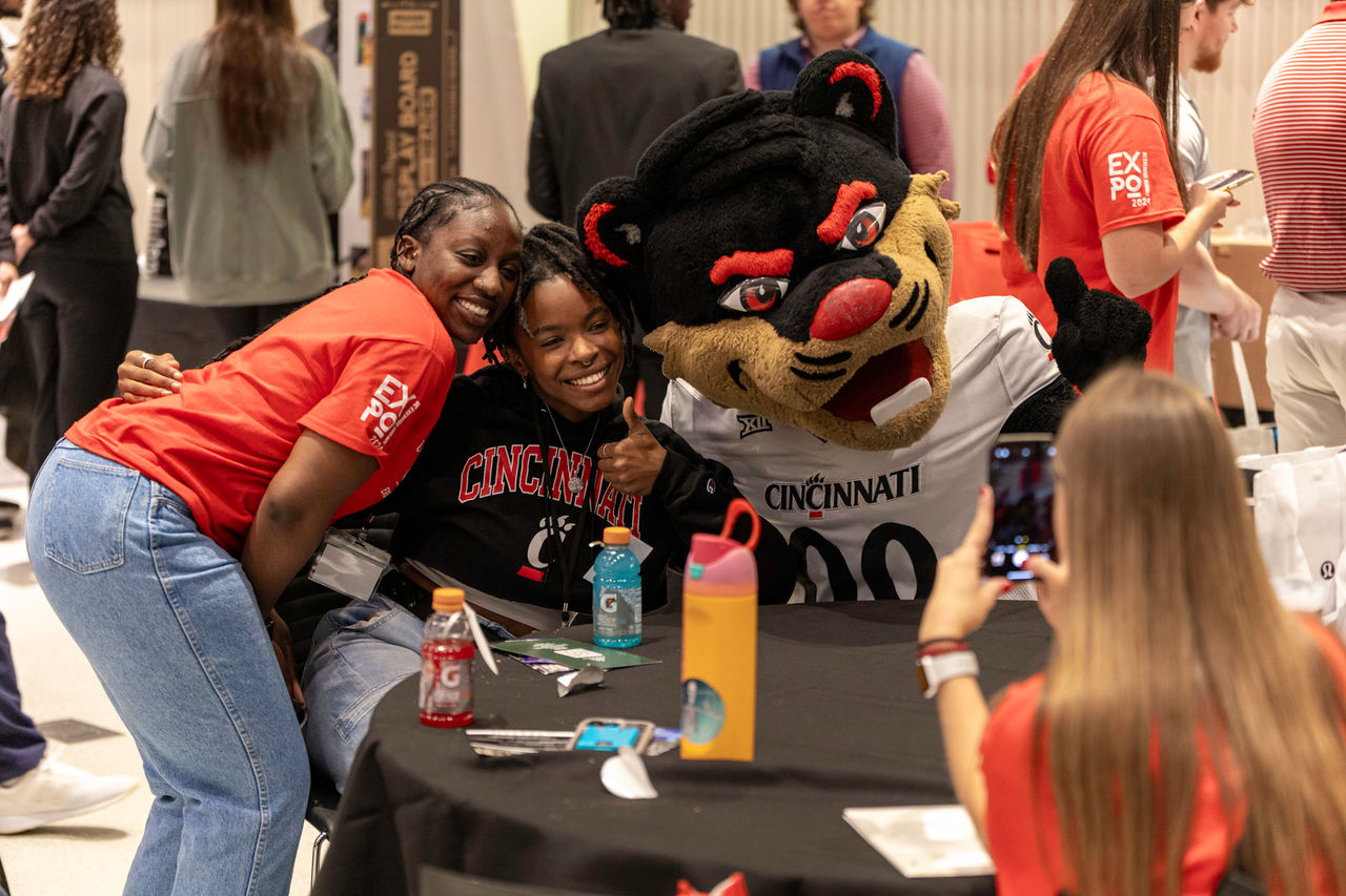 African American female students smiling with the UC Bearcat Mascot