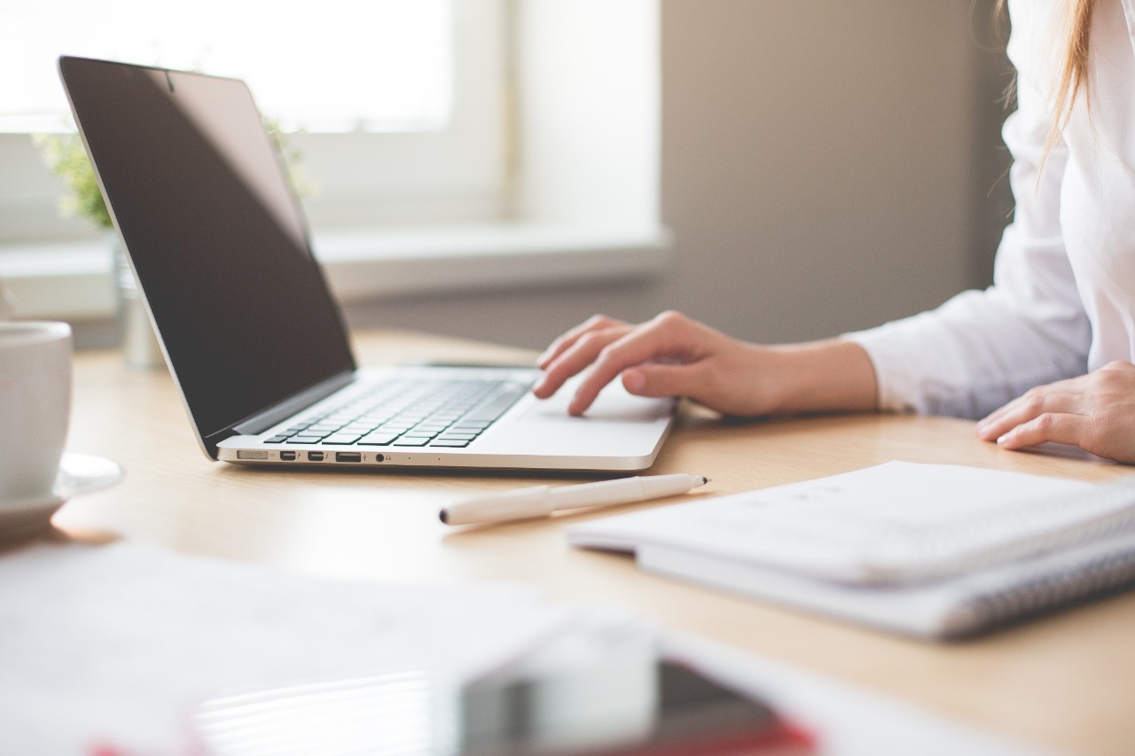 A picture of someone working at a laptop